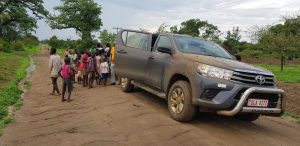 Picture of our car stuck in the mud on our way to a hard to reach area.