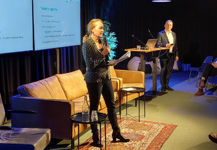 Photo of Barbara from Wemos in the front and Arnold from Tax Justice NL, on stage moderating a session at the Afrikadag at Pakhuis De Zwijger.